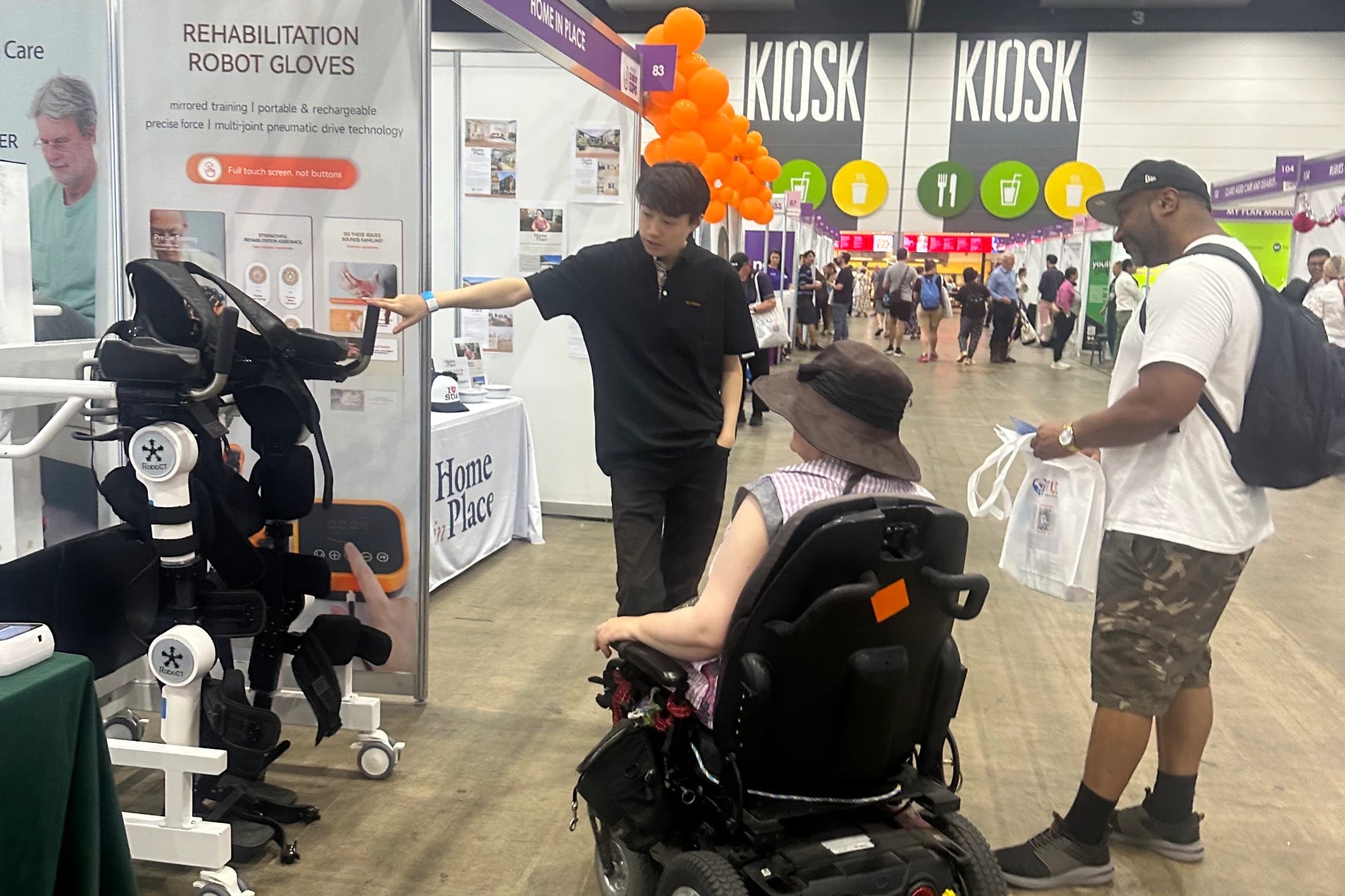 People learn about the RoboCT medical exoskeleton at MelbourneDisability Expo 2024.