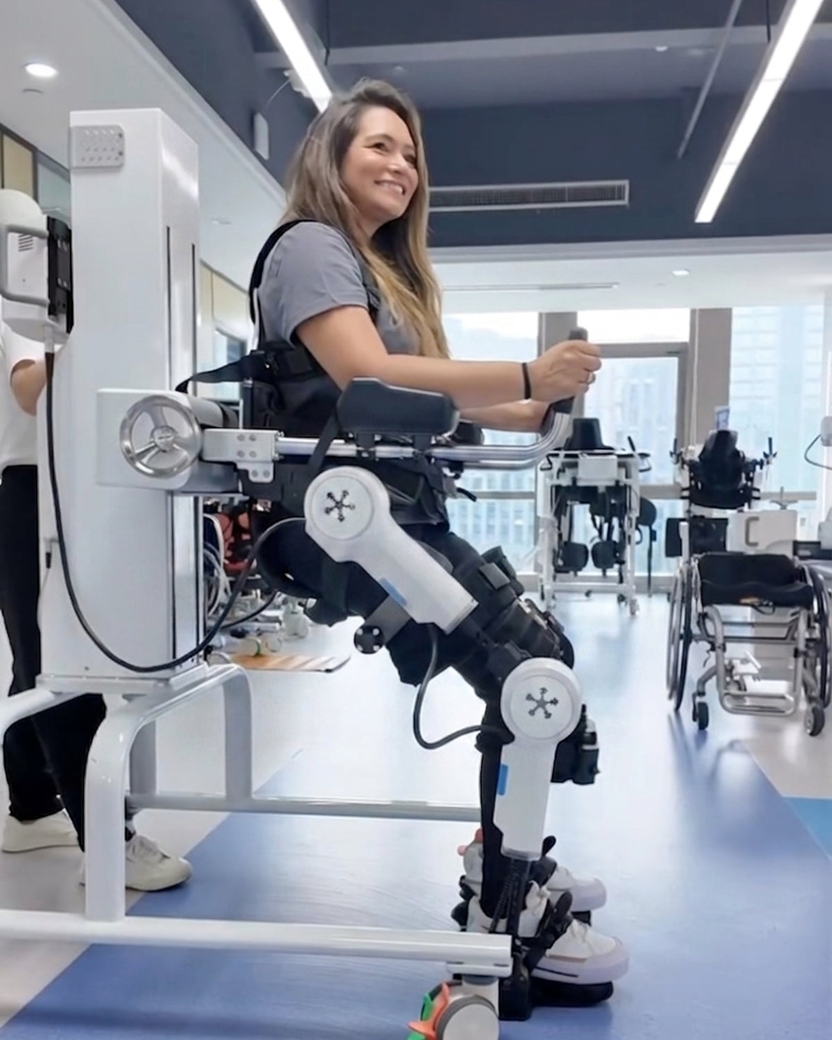 A woman is trying the RoboCT UGO medical exoskeleton.